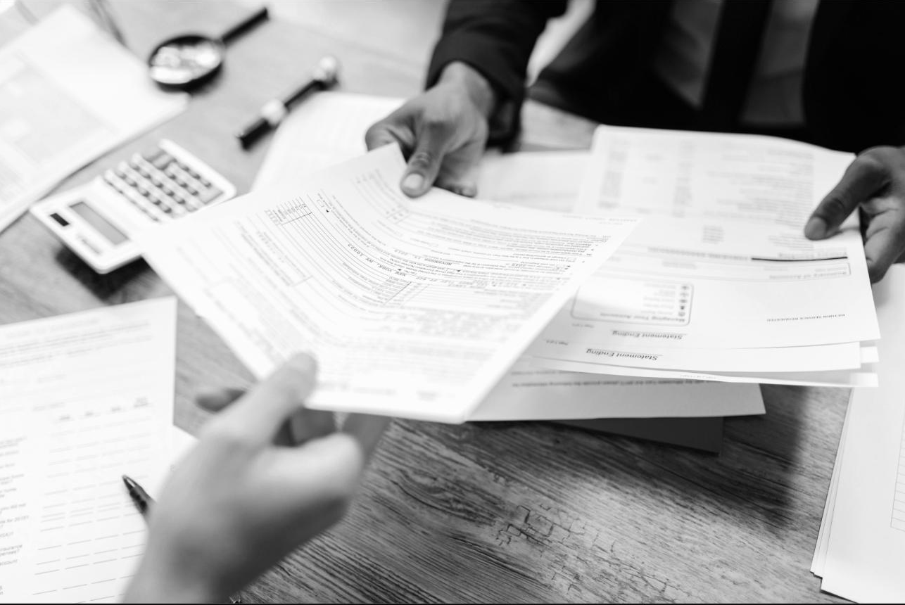 Two colleagues reviewing printed documents together