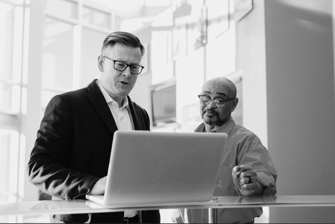 Two colleagues collaborating at a laptop